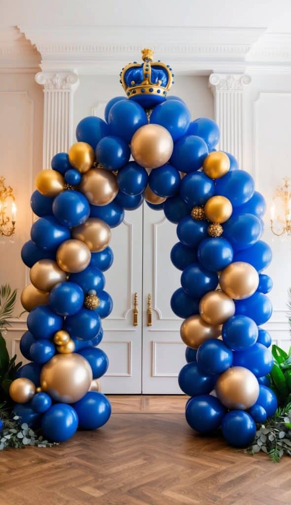 A decorative arch made of blue and gold balloons, topped with a crown, stands in front of white double doors in an elegant room with wooden floors and wall sconces.