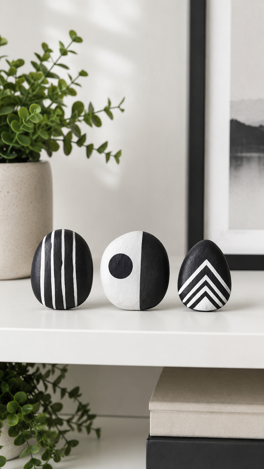Black and white tuxedo penguin painted rock with a white belly and tiny orange beak.