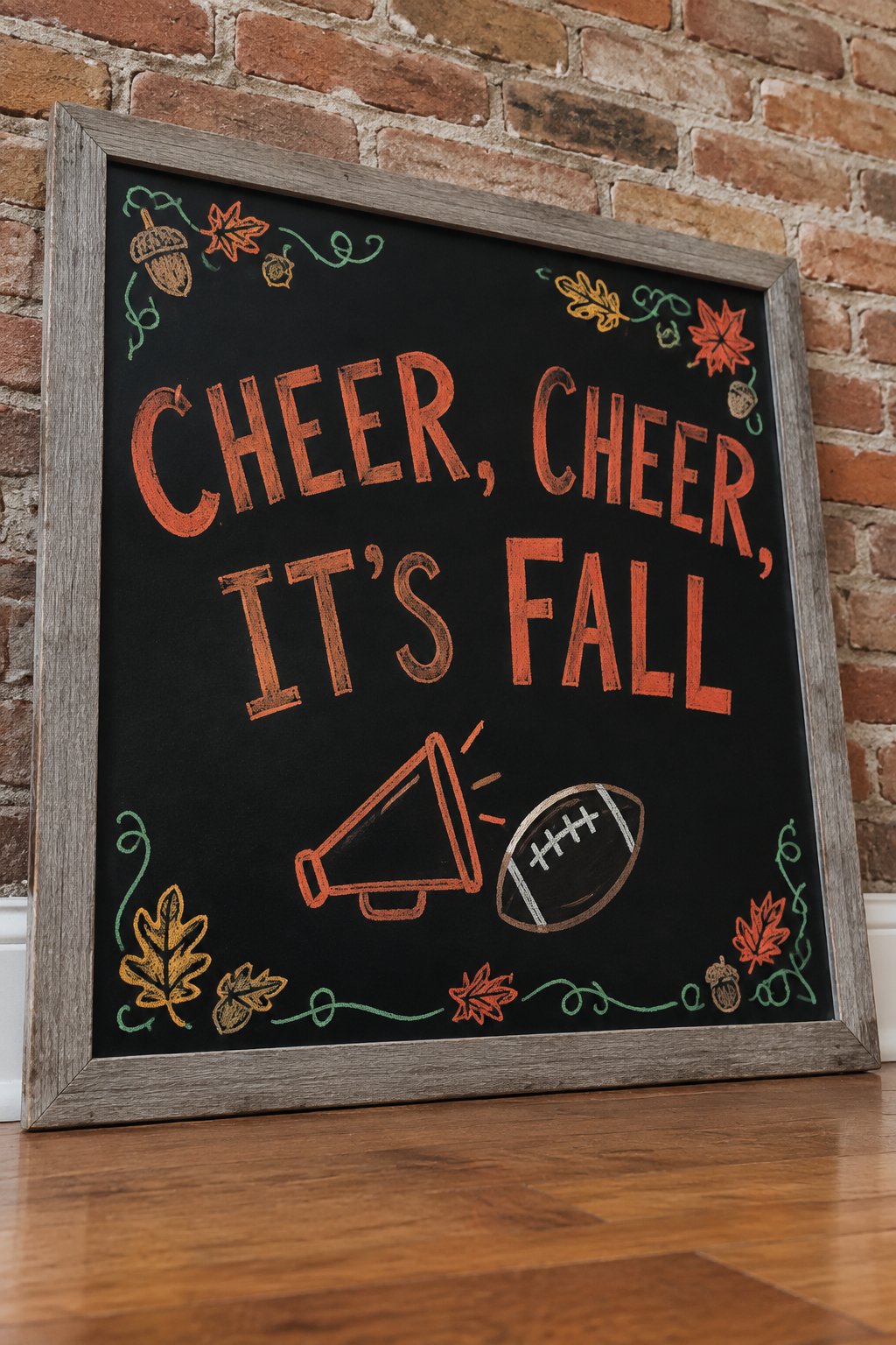Cheer for Fall Board: a framed fall chalkboard sign reading "Cheer, Cheer, It's Fall", hand-drawn in chalk with a small megaphone beside a football.