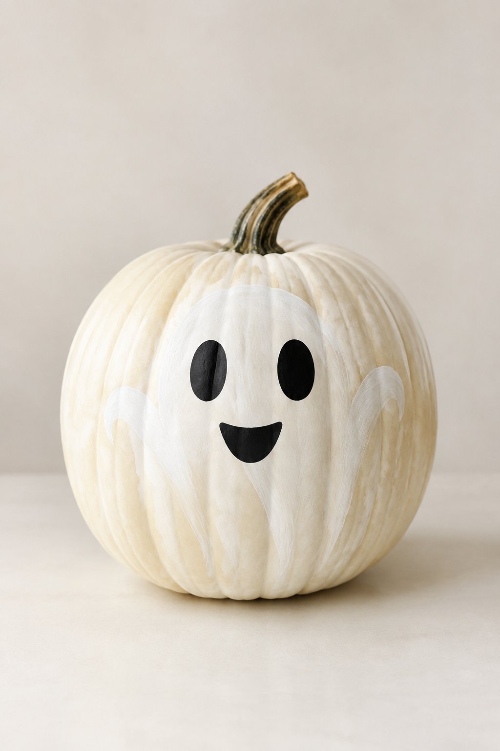 Smiling Ghost Face on a White Pumpkin - painted pumpkin faces